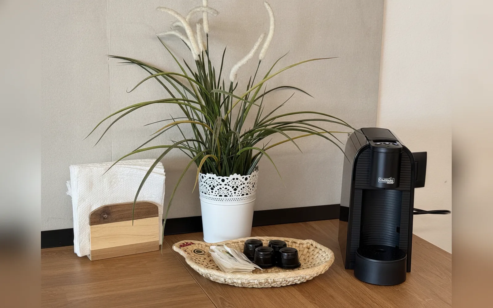 The coffee corner with espresso machine, capsules and clean towels