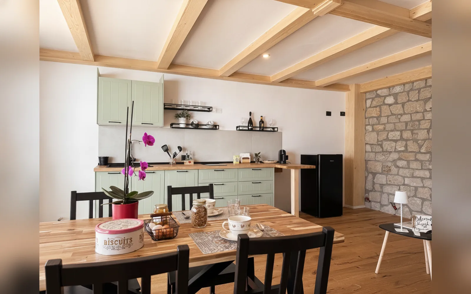 The studio's sage-green kitchen and dining table