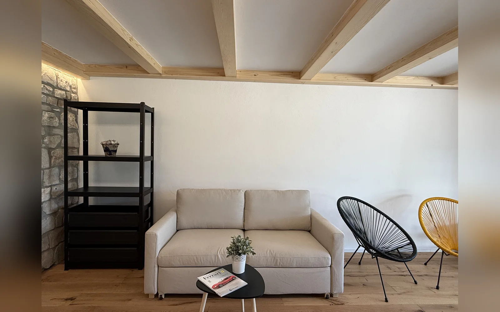 The studio's sitting corner with sofa, armchairs and bookcase