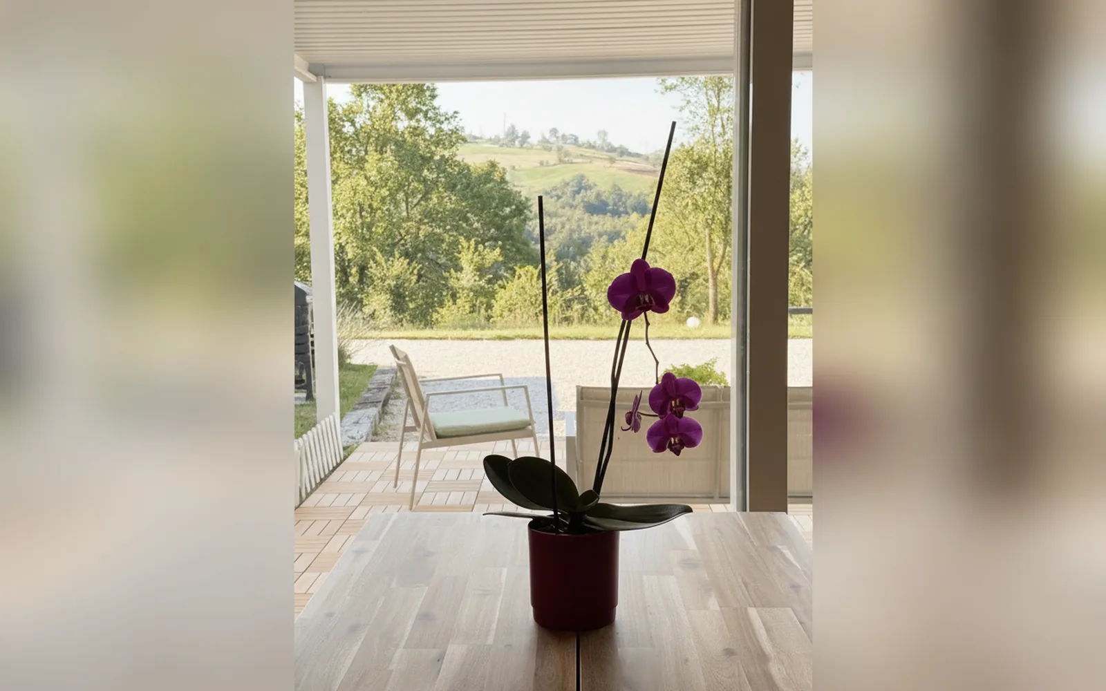 The living-room glass wall opening onto the patio and the hills